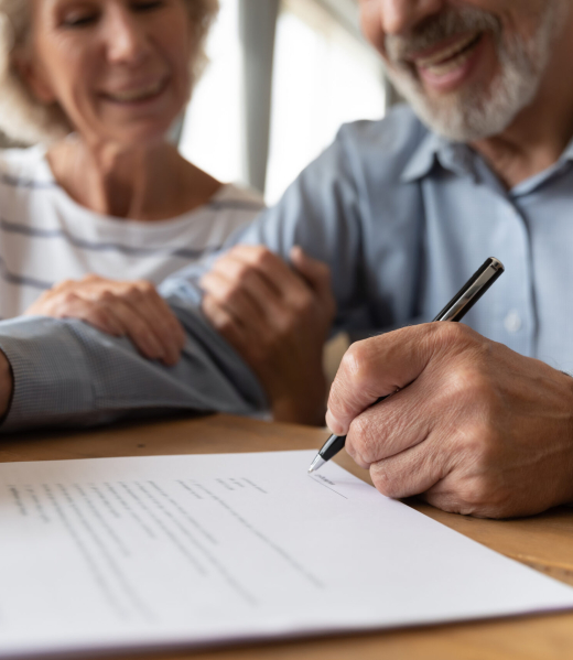 Close,Up,Of,60s,Husband,And,Wife,Sit,At,Desk